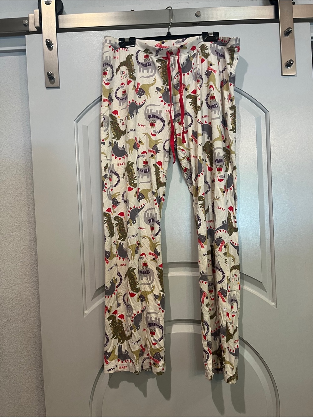 Max Studio cream Holiday Dinosaur Pajama Pants with Red Drawstring. Rawrr!